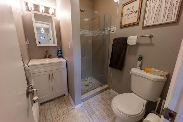 full bath featuring a stall shower, toilet, and vanity