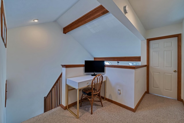 carpeted home office featuring baseboards and vaulted ceiling