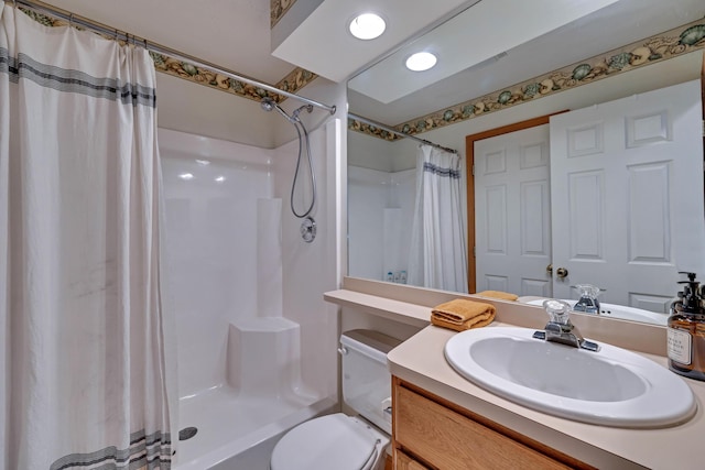 full bath with curtained shower, vanity, and toilet