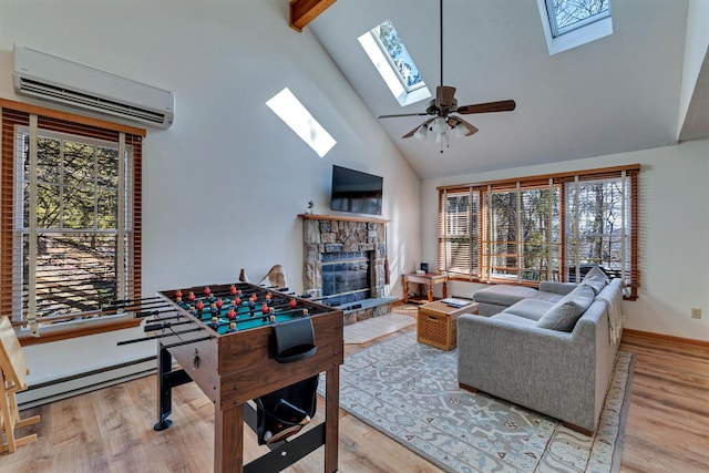 game room with a baseboard radiator, wood finished floors, a fireplace, and a wall mounted AC