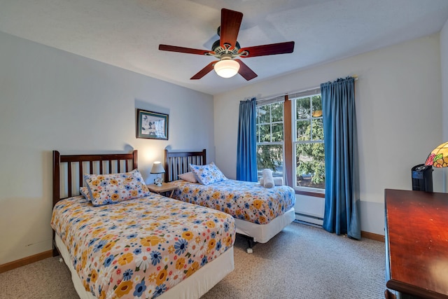 carpeted bedroom featuring baseboards, baseboard heating, and ceiling fan