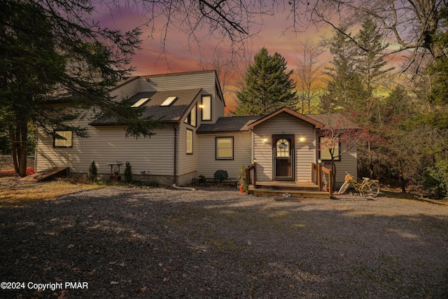 view of front of property featuring roof with shingles