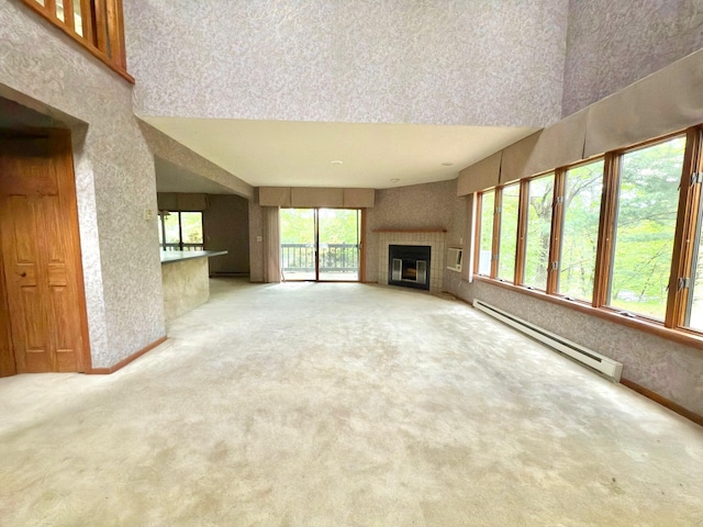 402 Shinymountain Ct, Greentown, PA 18426 - unfurnished living room with a baseboard heating unit, carpet floors, a fireplace, a high ceiling, and wallpapered walls