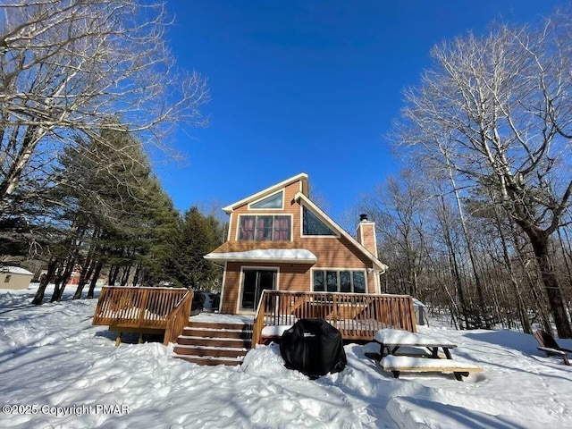 156 Poplar Pl, Blakeslee, PA 18610 - snow covered house with a chimney and a wooden deck