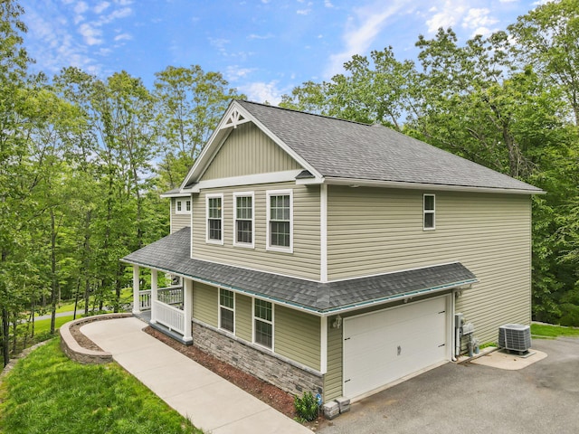 1127 Fillmore St, East Stroudsburg, PA 18301 - view of side of property with a shingled roof, an attached garage, a porch, and driveway
