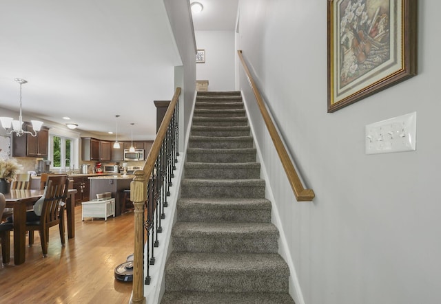 1127 Fillmore St, East Stroudsburg, PA 18301 - stairway featuring a chandelier and wood finished floors