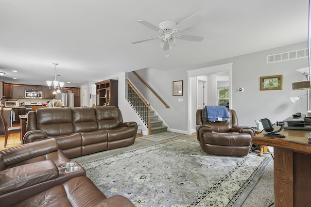 1127 Fillmore St, East Stroudsburg, PA 18301 - living area with stairway, a ceiling fan, a chandelier, and recessed lighting