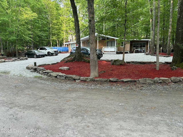 view of front of property with a forest view