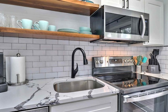 3360 Rte 940, Mount Pocono, PA 18344 - kitchen featuring open shelves, appliances with stainless steel finishes, decorative backsplash, and white cabinets