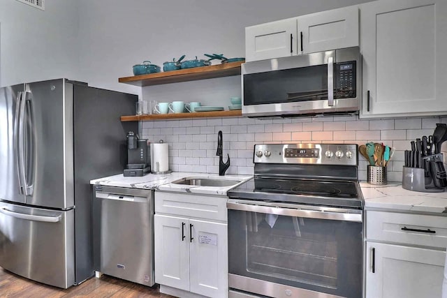 3360 Rte 940, Mount Pocono, PA 18344 - kitchen with stainless steel appliances, wood finished floors, tasteful backsplash, and a sink