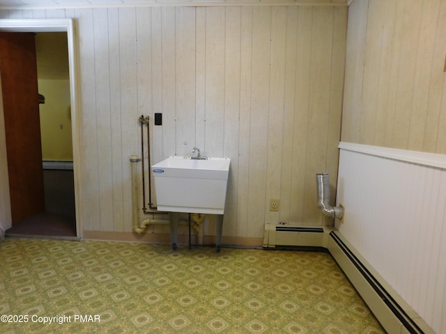 washroom with a baseboard heating unit, tile patterned floors, and a sink