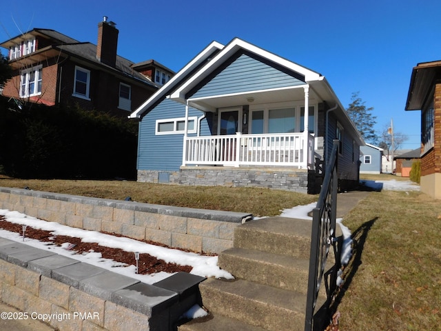 view of front of home featuring a porch and a front lawn