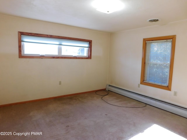 unfurnished room featuring baseboard heating, baseboards, visible vents, and carpet floors