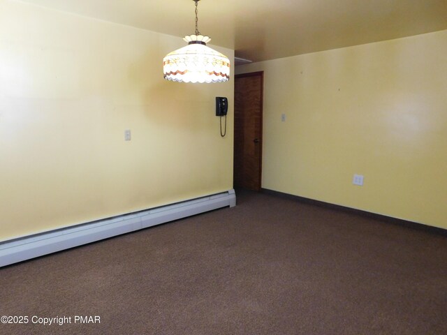 unfurnished room featuring a baseboard radiator and dark carpet