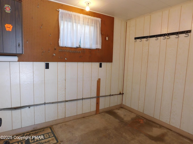 basement featuring wooden walls