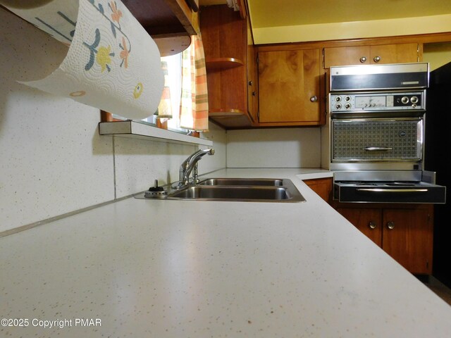 kitchen featuring wall oven and sink