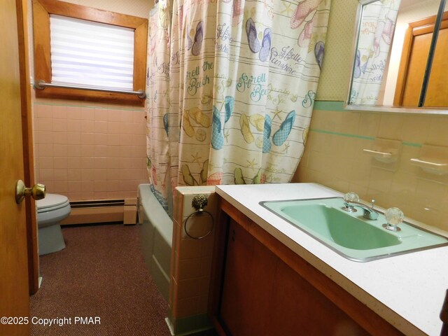 full bathroom with toilet, tile walls, baseboard heating, vanity, and shower / bathtub combination with curtain