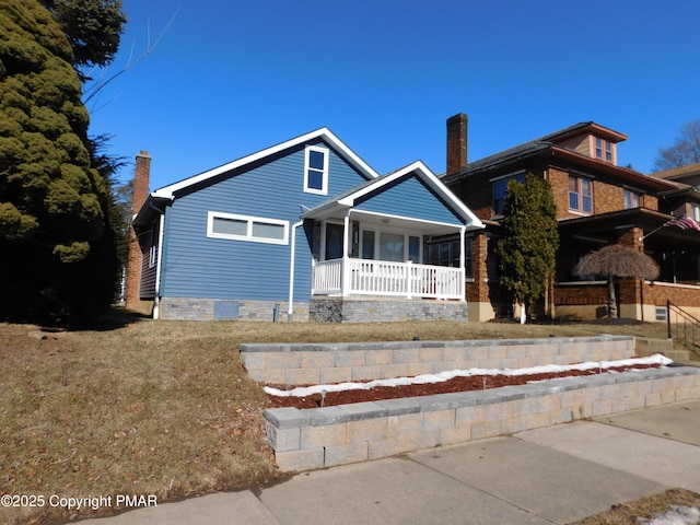 view of front facade with a front yard and covered porch