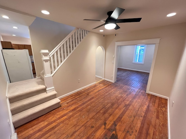 interior space with recessed lighting, wood-type flooring, arched walkways, baseboards, and stairs