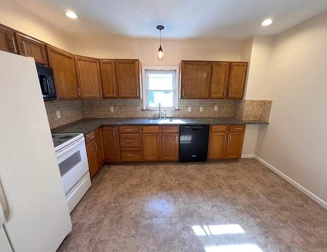 kitchen with dark countertops, decorative backsplash, brown cabinets, black appliances, and a sink