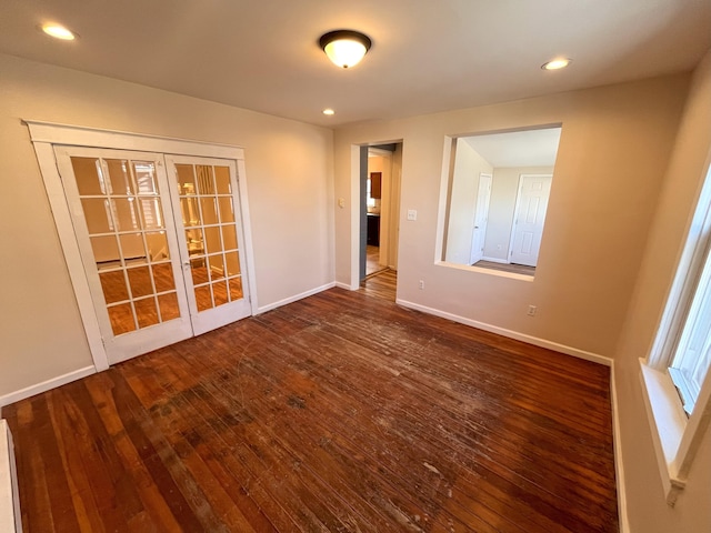 spare room with recessed lighting, french doors, dark wood-style flooring, and baseboards