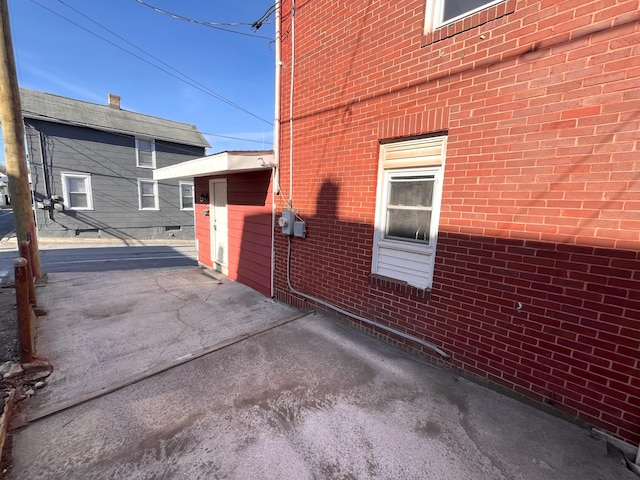 view of property exterior with brick siding