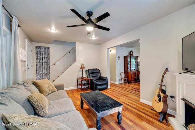 172 Steep Hill Rd, Cresco, PA 18326 - living room featuring light wood finished floors, stairs, and a ceiling fan