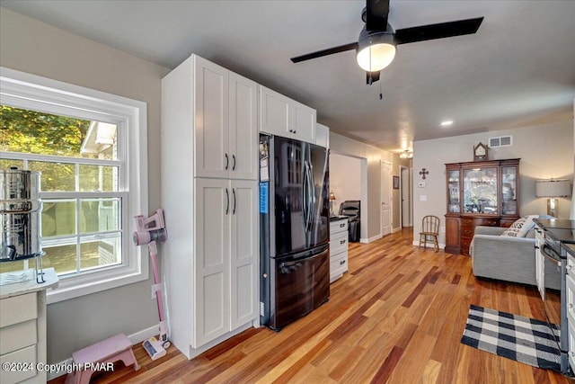 172 Steep Hill Rd, Cresco, PA 18326 - kitchen featuring freestanding refrigerator, white cabinets, light wood-style floors, open floor plan, and ceiling fan