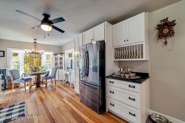 172 Steep Hill Rd, Cresco, PA 18326 - kitchen with freestanding refrigerator, dark countertops, white cabinetry, light wood-type flooring, and a chandelier