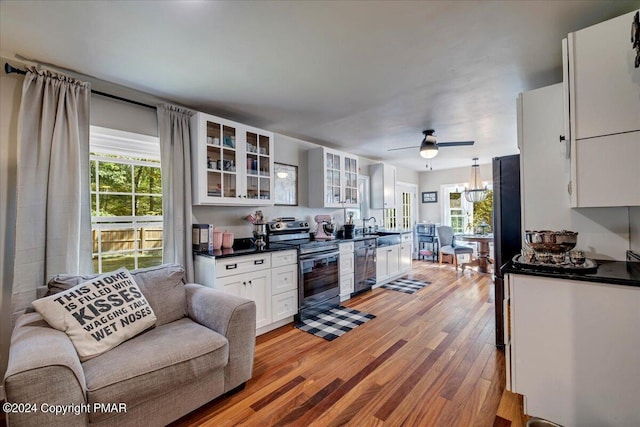 172 Steep Hill Rd, Cresco, PA 18326 - kitchen with stainless steel appliances, dark countertops, light wood finished floors, and white cabinetry