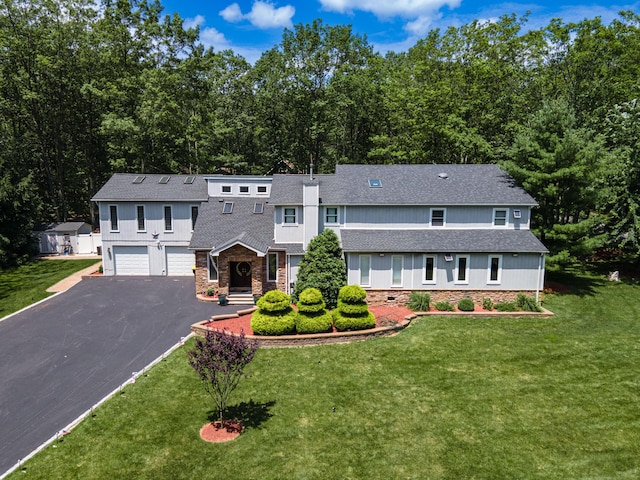 1555 Longleaf Dr, Effort, PA 18330 - view of front of home with an attached garage, driveway, a shingled roof, a front yard, and stone siding