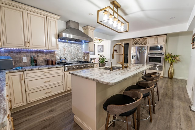 1555 Longleaf Dr, Effort, PA 18330 - kitchen featuring cream cabinets, wall chimney range hood, and appliances with stainless steel finishes