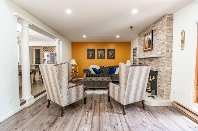 1555 Longleaf Dr, Effort, PA 18330 - living room with a baseboard radiator, ornate columns, wood finished floors, and recessed lighting