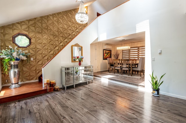 1555 Longleaf Dr, Effort, PA 18330 - foyer entrance with a chandelier, wood finished floors, high vaulted ceiling, and a wall unit AC