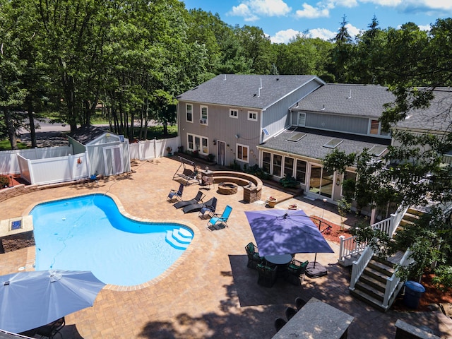 1555 Longleaf Dr, Effort, PA 18330 - view of pool with an outdoor fire pit, a fenced backyard, a patio area, outdoor dining space, and an outbuilding