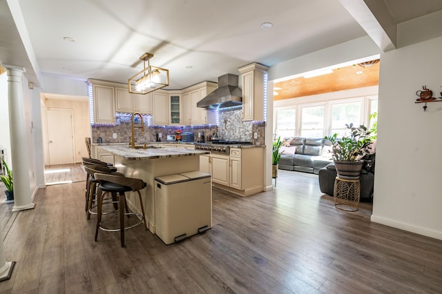 1555 Longleaf Dr, Effort, PA 18330 - kitchen with cream cabinets, wall chimney exhaust hood, stainless steel gas stovetop, an island with sink, and tasteful backsplash