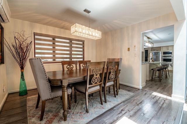 1555 Longleaf Dr, Effort, PA 18330 - dining space with a wall mounted AC, a chandelier, and wood finished floors