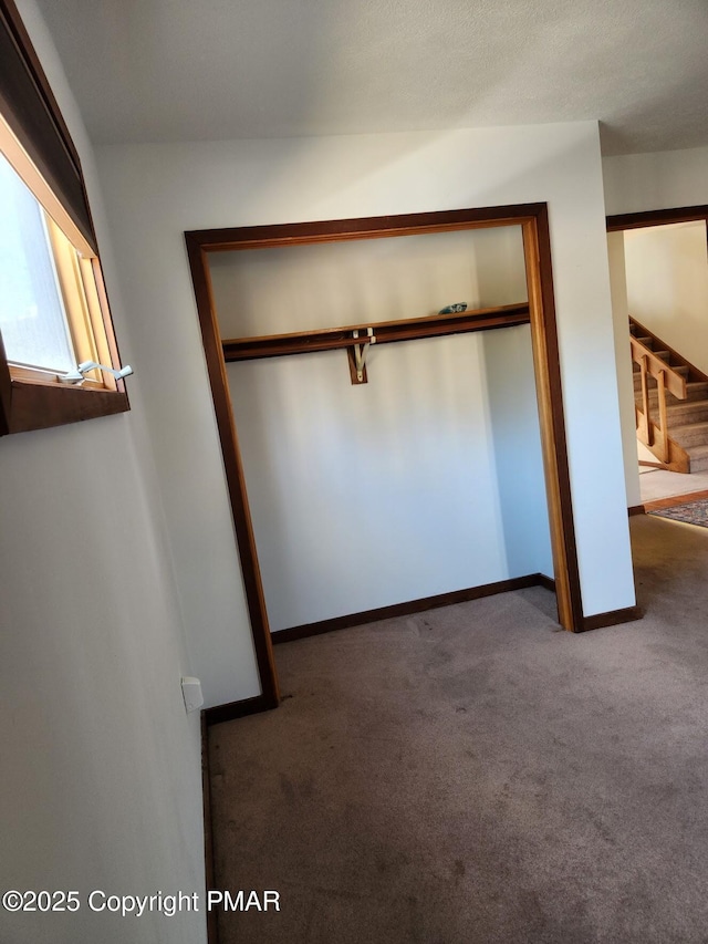 unfurnished bedroom featuring a closet and carpet floors