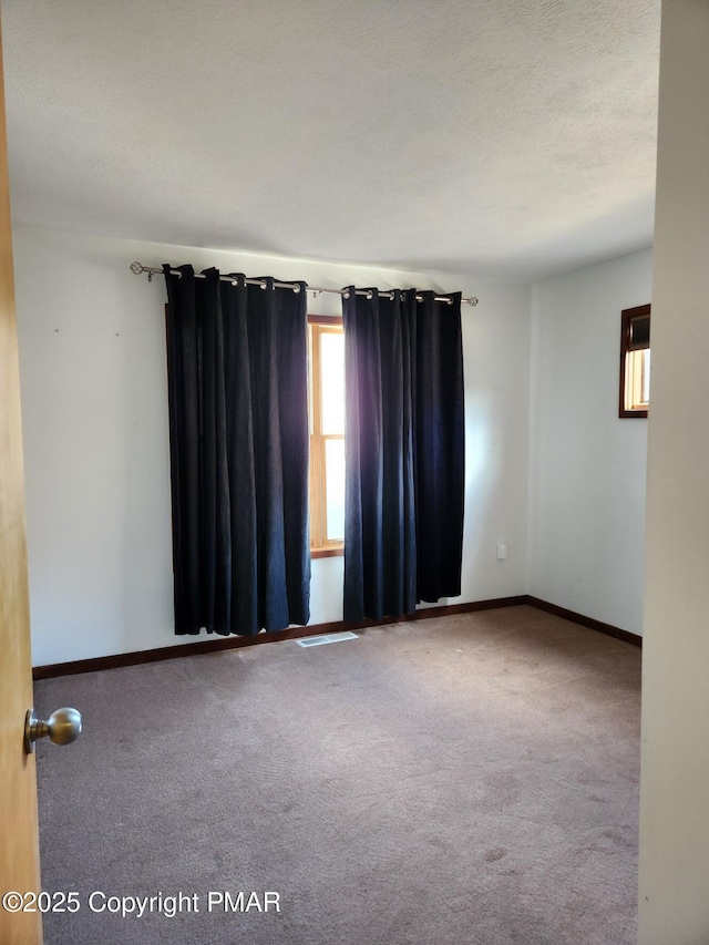 unfurnished room with carpet floors