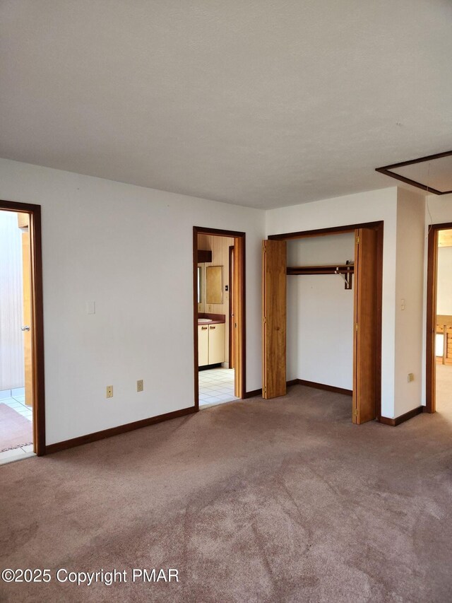 unfurnished bedroom featuring access to exterior, carpet flooring, and a closet