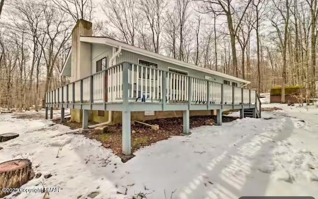 exterior space with a chimney and a deck