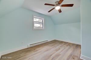 3109 Snowden Dr, Bushkill, PA 18324 - additional living space with baseboard heating, vaulted ceiling, a ceiling fan, and wood finished floors