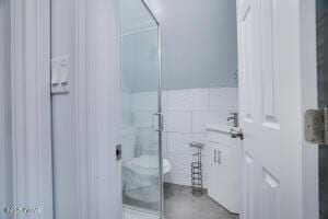 3109 Snowden Dr, Bushkill, PA 18324 - bathroom with a shower stall, tile walls, and vanity