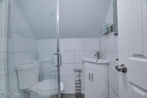 3109 Snowden Dr, Bushkill, PA 18324 - full bathroom with tile walls, vanity, and a stall shower