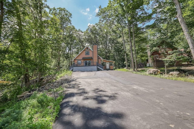 3109 Snowden Dr, Bushkill, PA 18324 - rustic home featuring asphalt driveway and a chimney