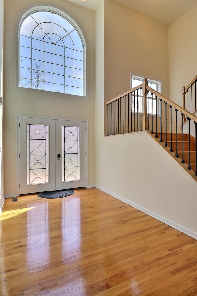 301 Reagan Dr, East Stroudsburg, PA 18301 - foyer with baseboards, a towering ceiling, wood finished floors, and stairway