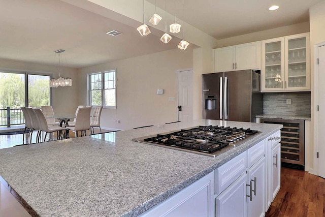 301 Reagan Dr, East Stroudsburg, PA 18301 - kitchen with beverage cooler, stainless steel appliances, white cabinetry, visible vents, and glass insert cabinets