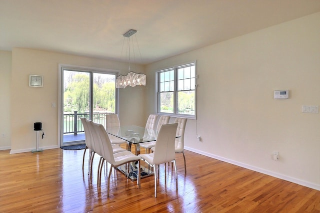 301 Reagan Dr, East Stroudsburg, PA 18301 - dining area with baseboards, light wood-style flooring, and a notable chandelier