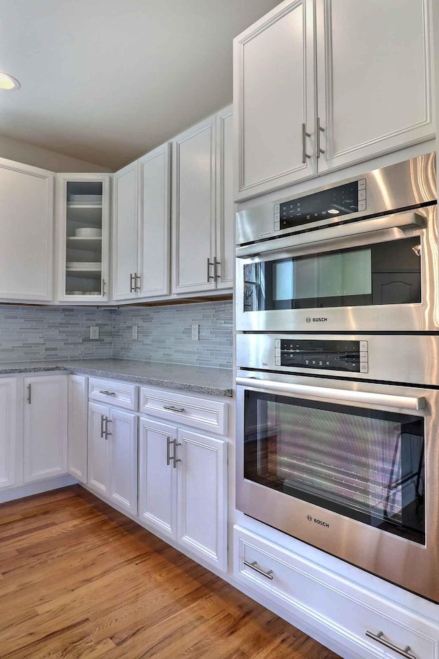 301 Reagan Dr, East Stroudsburg, PA 18301 - kitchen with tasteful backsplash, stainless steel double oven, and white cabinetry