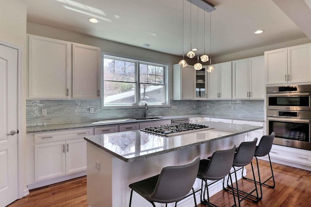 301 Reagan Dr, East Stroudsburg, PA 18301 - kitchen featuring a sink, a kitchen breakfast bar, stainless steel appliances, white cabinetry, and a kitchen island
